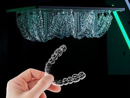LuxCreo direct 3D-printed clear aligner being removed from build platform